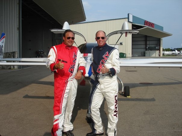 rocket racing granger and friend standing next to a plane