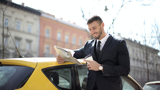 guy reading newspaper next to a car-The Power of Positivity How a Positive Mindset Can Transform Your Business-feat