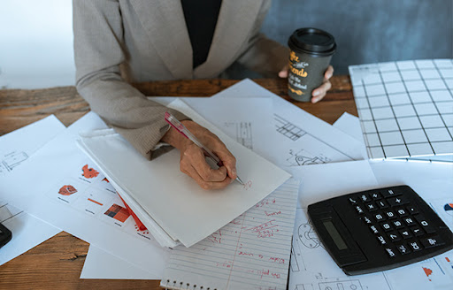 woman checking paperwork Work Smarter, Not Harder Strategies for Boosting Productivity body