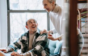 woman talking and smiling with a man The Art of Effective Communication in Leadership body